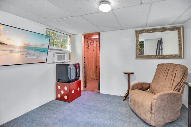 a view of a chair and table in backyard of the house