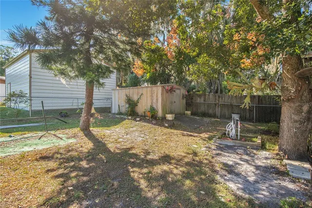 a view of a house with backyard and garden
