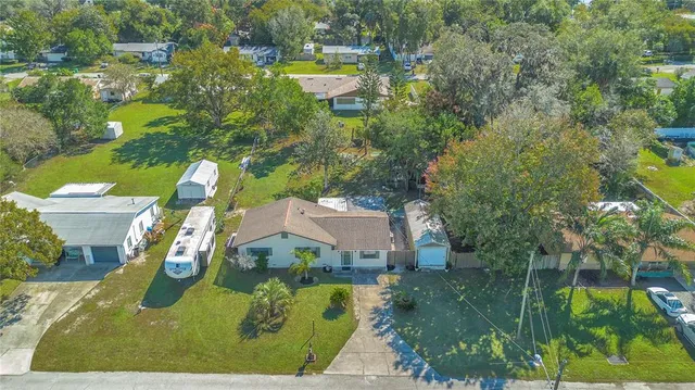 an aerial view of a house with swimming pool outdoor seating and yard