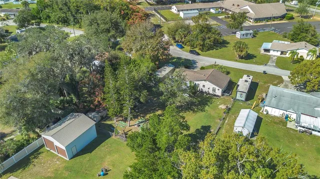 an aerial view of residential house with outdoor space and swimming pool