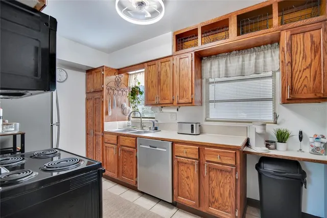 a kitchen with stainless steel appliances a sink stove and cabinets