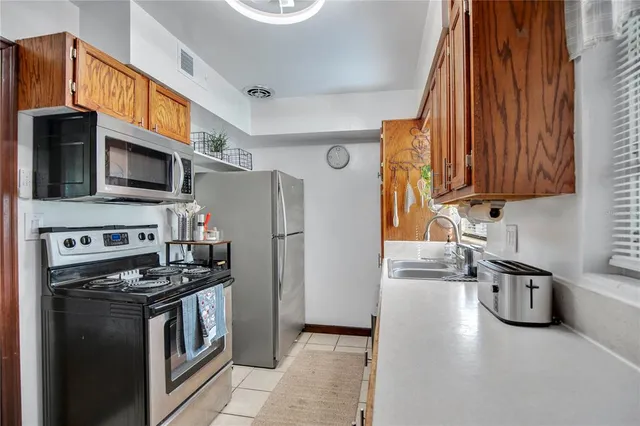 a kitchen with stainless steel appliances a stove a microwave and a refrigerator