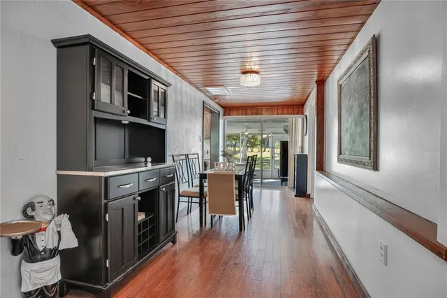 a kitchen with stove and wooden floor