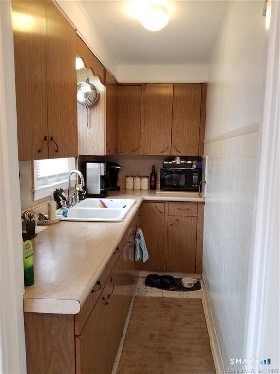 26 4th Street Hamden, CT 06514 - Photo 8 of 40 a kitchen with a sink a stove and cabinets