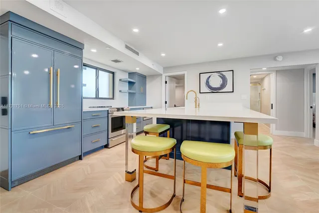 a kitchen with a table chairs refrigerator and microwave