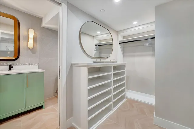 a bathroom with a sink a mirror and a shower