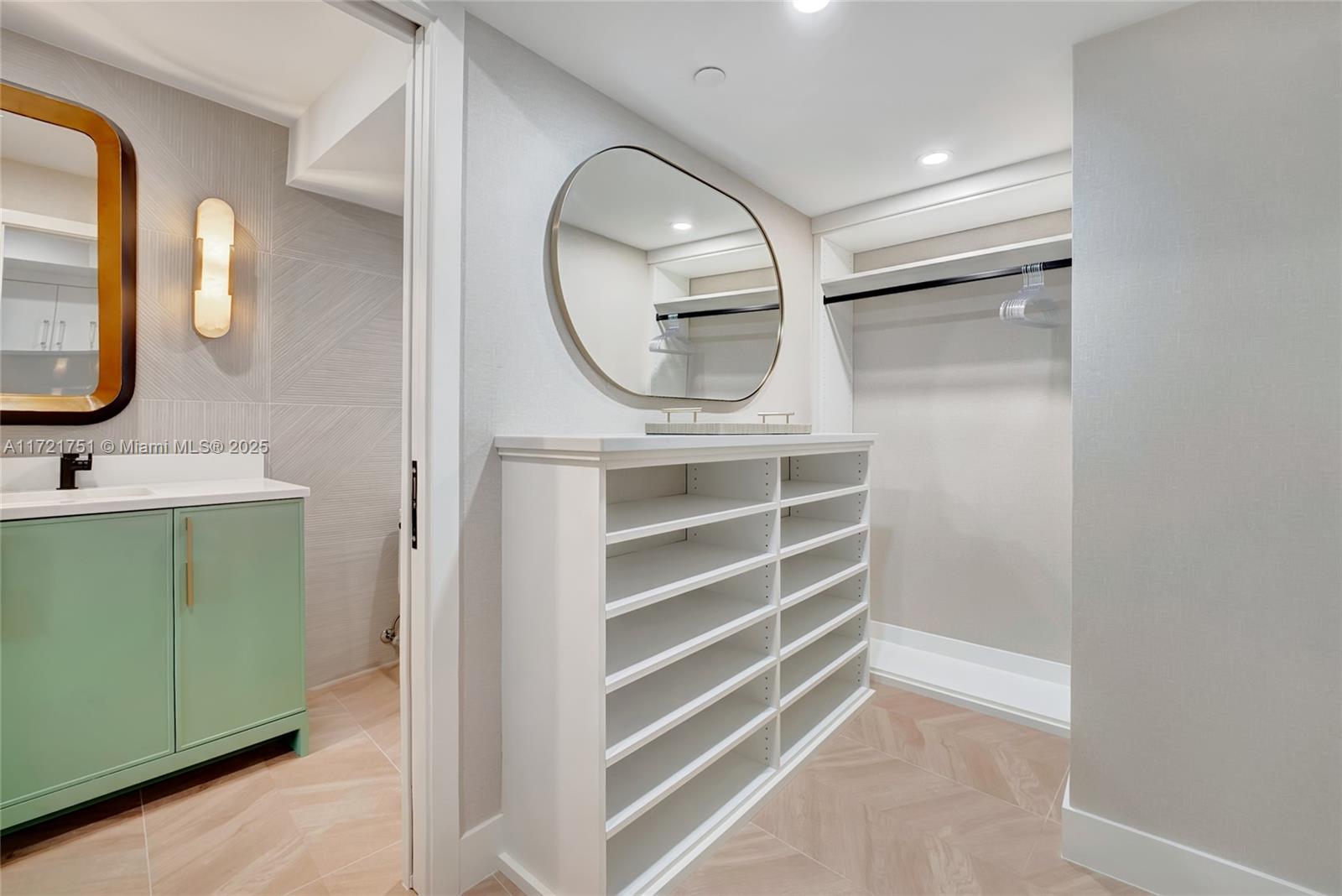 300 Ocean Trail Way, Unit 702 Jupiter, FL 33477 - Photo 11 of 30 a bathroom with a sink a mirror and a shower