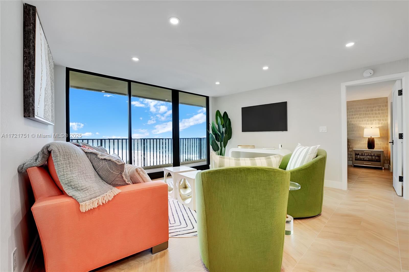 300 Ocean Trail Way, Unit 702 Jupiter, FL 33477 - Photo 14 of 30 a living room with furniture a large window and a flat screen tv