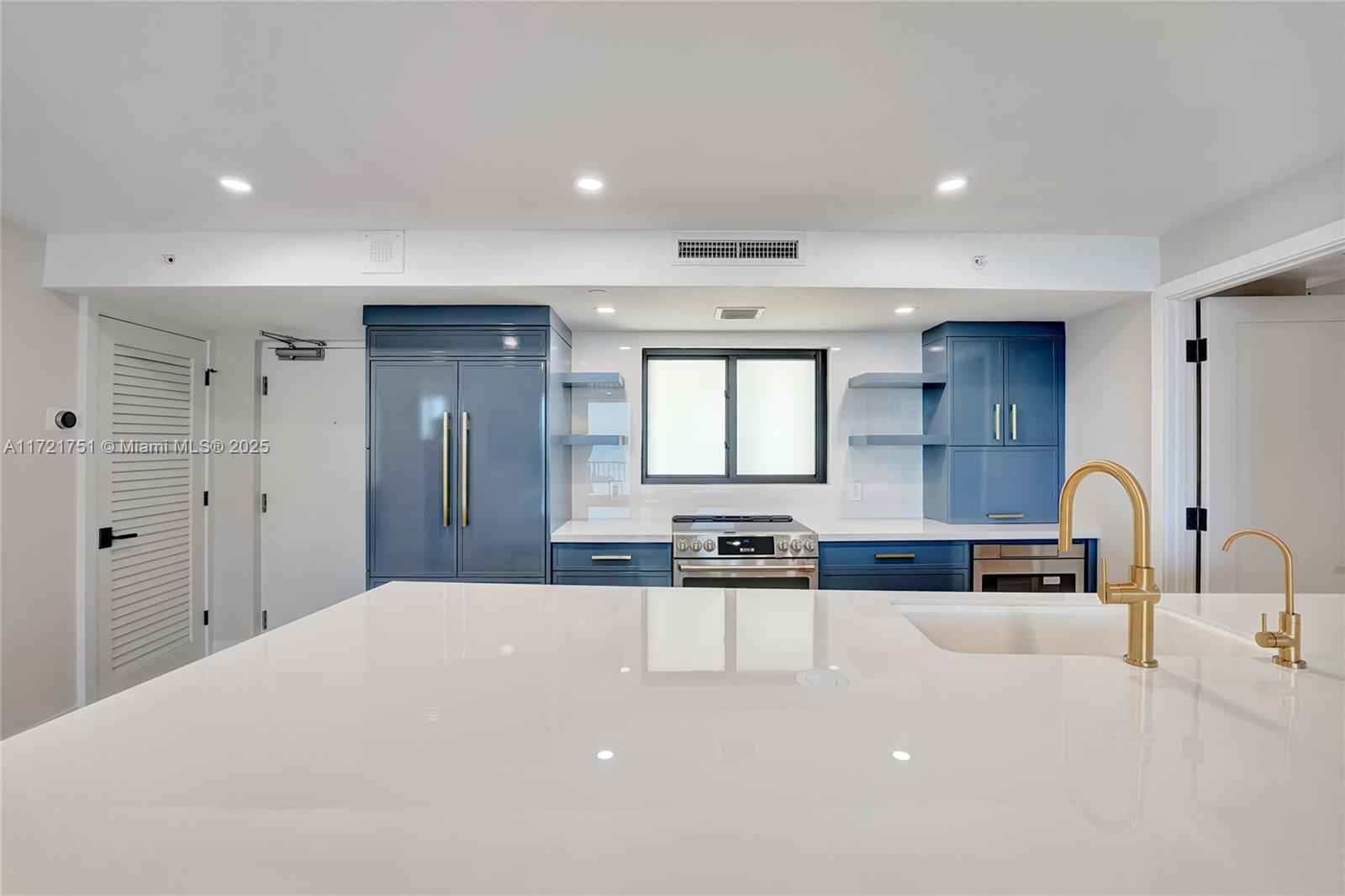 300 Ocean Trail Way, Unit 702 Jupiter, FL 33477 - Photo 15 of 30 a kitchen with stainless steel appliances a sink a stove a refrigerator cabinets and a dining table