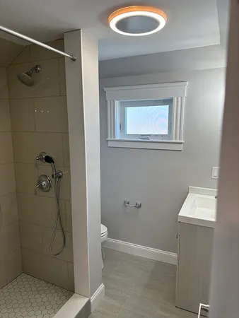 a bathroom with a granite countertop shower and a sink