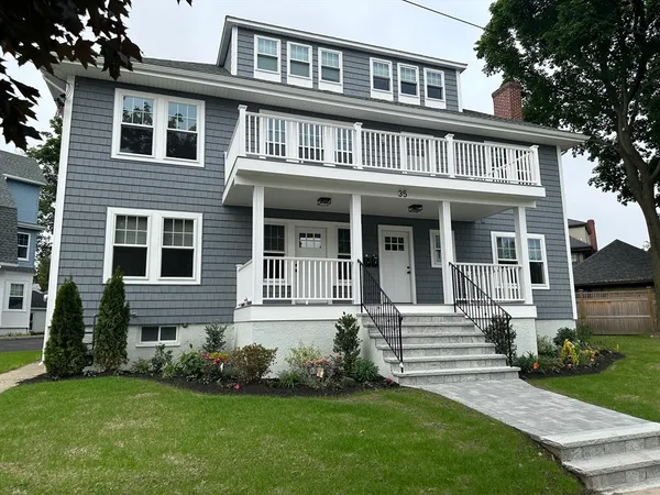 a front view of a house with a garden