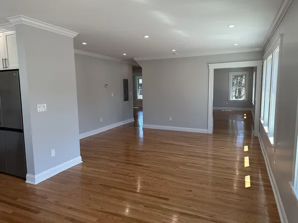 a view of a hallway with wooden floor
