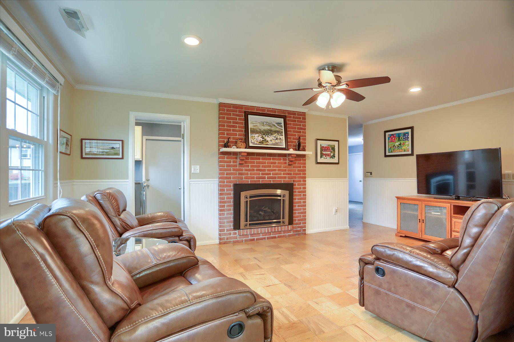 24 Neptune Drive Joppa, MD 21085 - Photo 16 of 70 a living room with furniture a flat screen tv and a fireplace