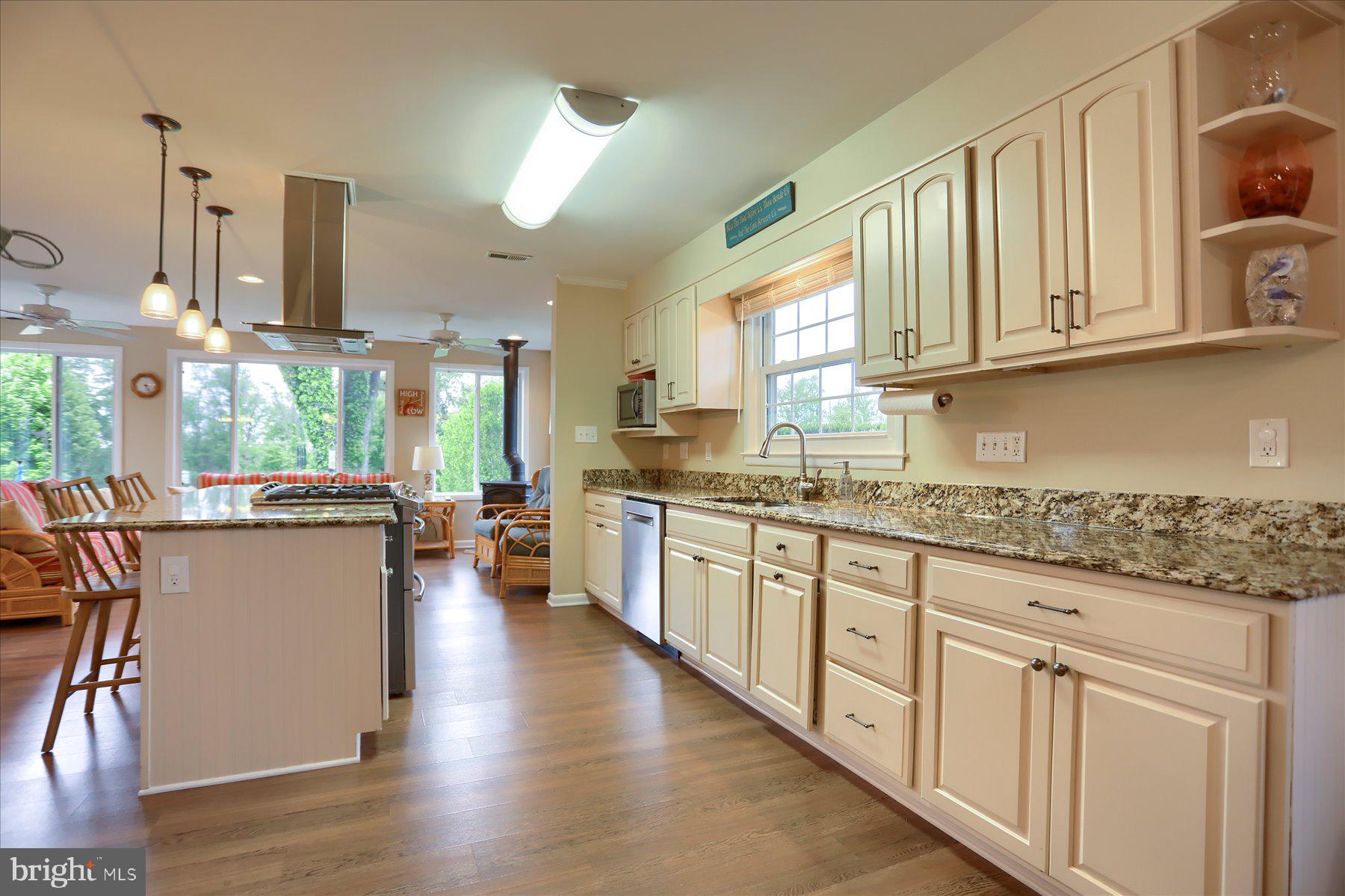 24 Neptune Drive Joppa, MD 21085 - Photo 22 of 70 a kitchen with stainless steel appliances granite countertop a lot of counter space and wooden floors