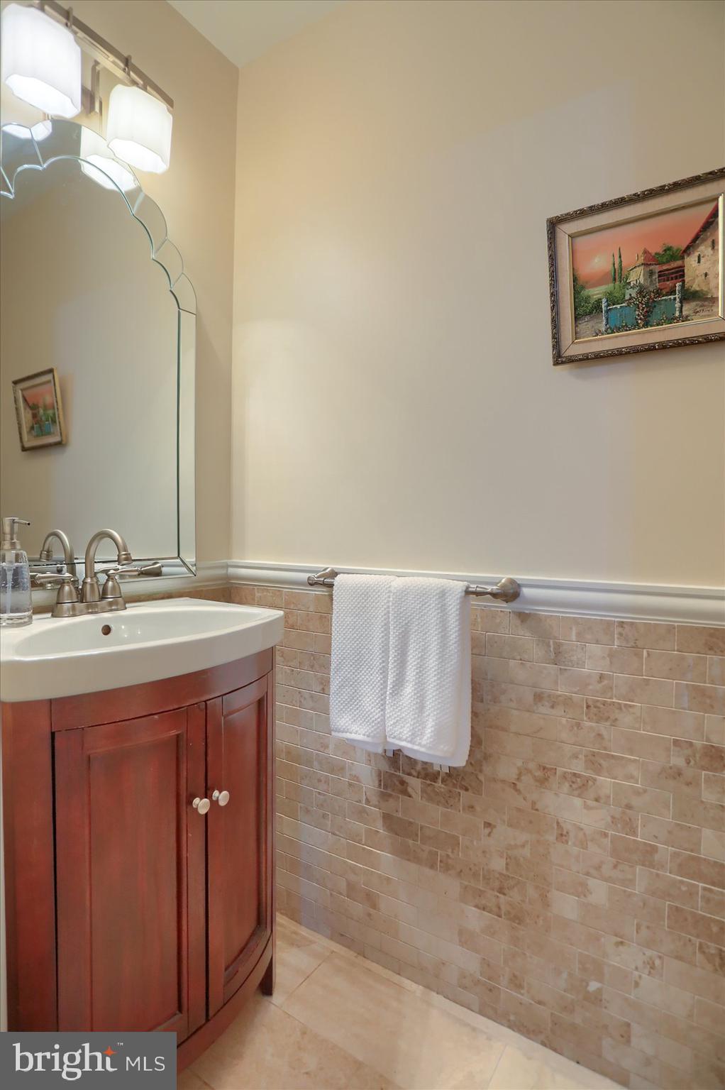 24 Neptune Drive Joppa, MD 21085 - Photo 35 of 70 a bathroom with a granite countertop sink a mirror and vanity