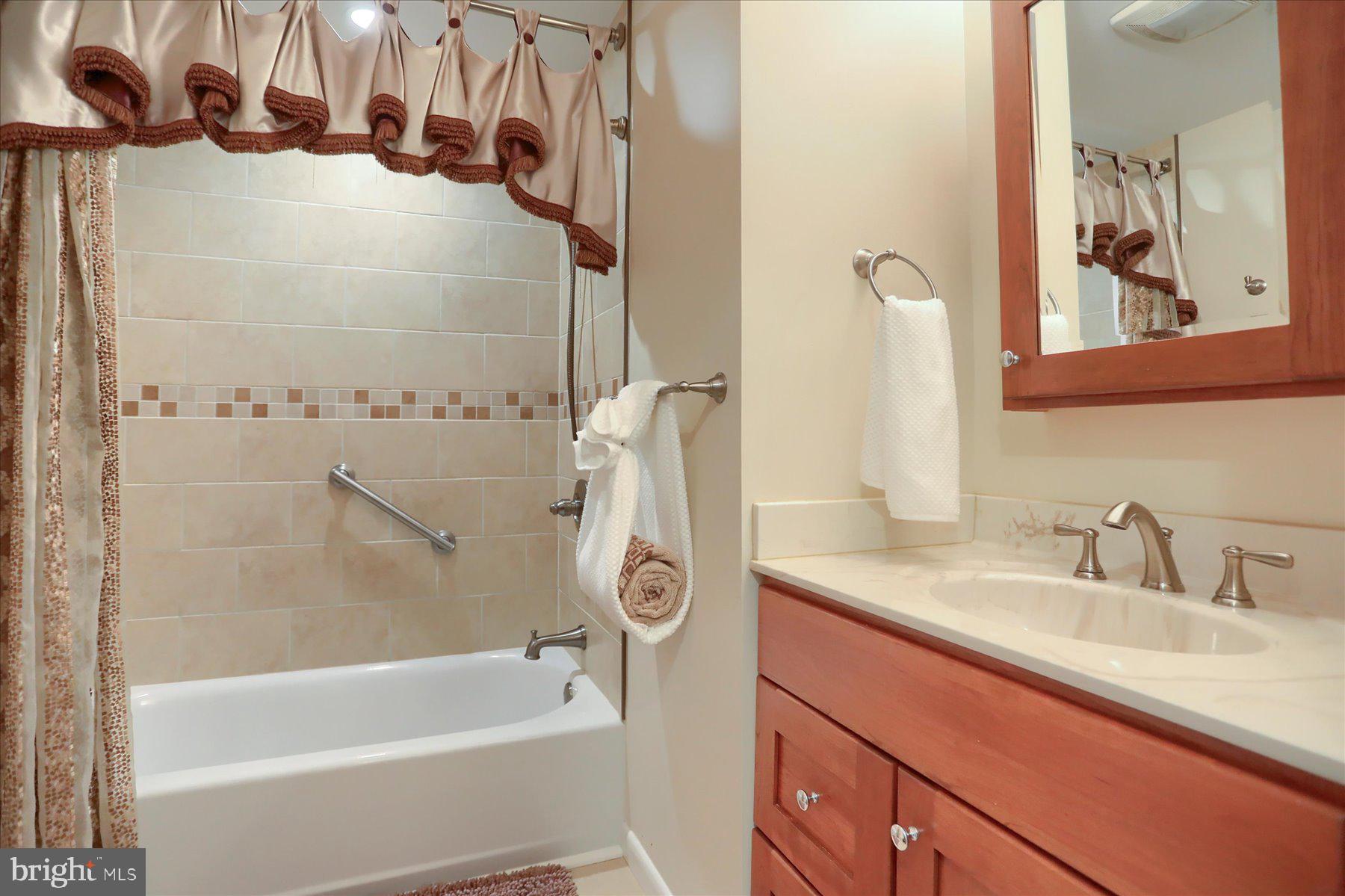 24 Neptune Drive Joppa, MD 21085 - Photo 36 of 70 a bathroom with a sink and a bathtub