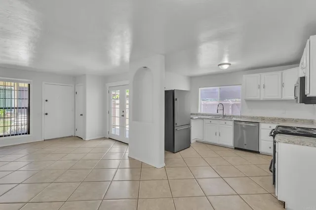 a kitchen with a refrigerator a sink and cabinets