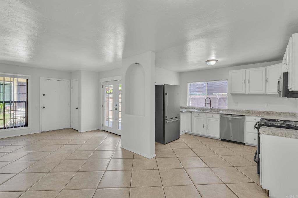 237 Rancho Drive, Unit C Chula Vista, CA 91911 - Photo 1 of 23 a kitchen with a refrigerator a sink and cabinets