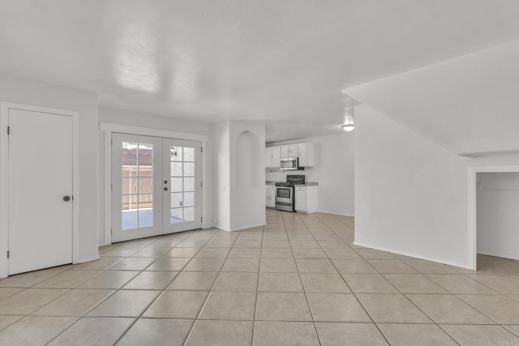237 Rancho Drive, Unit C Chula Vista, CA 91911 - Photo 3 of 23 a view of an empty room with kitchen and window