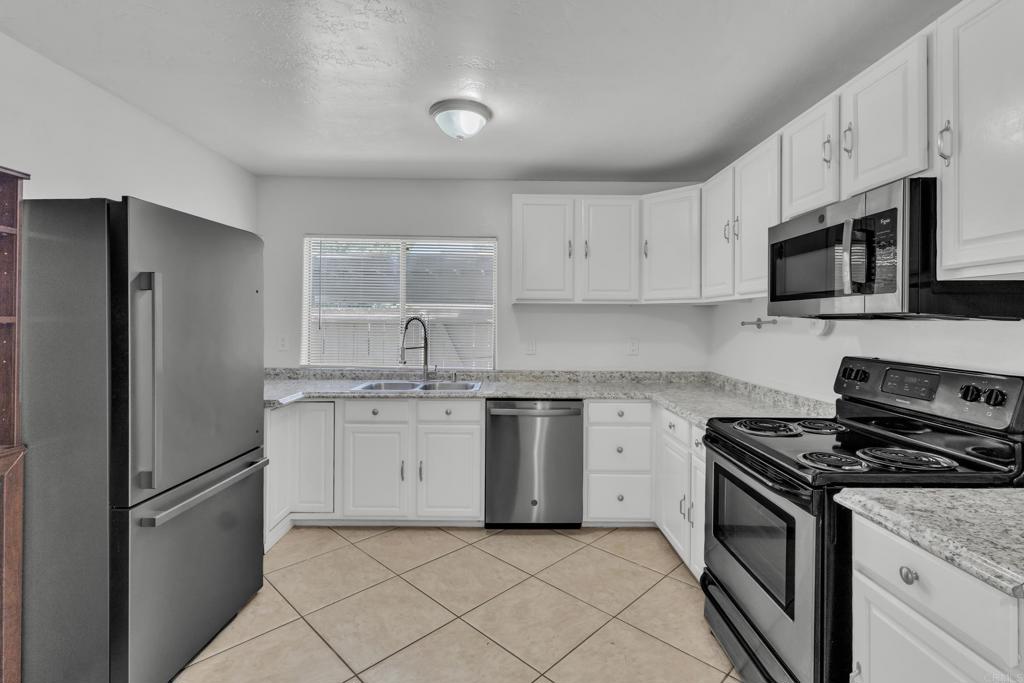 237 Rancho Drive, Unit C Chula Vista, CA 91911 - Photo 4 of 23 a kitchen with appliances a sink and cabinets