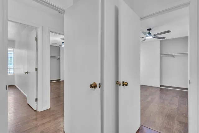 a view of a hallway with wooden floor