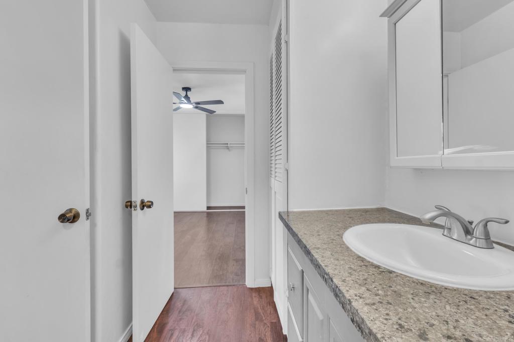 237 Rancho Drive, Unit C Chula Vista, CA 91911 - Photo 10 of 23 a bathroom with a granite countertop sink a mirror and shower