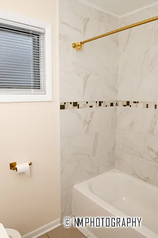 a bath tub sitting next to a white sink