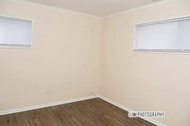 a view of a small space with wooden floor and a window