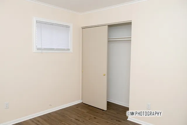 a view of an empty room with wooden floor