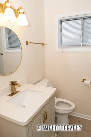 a bathroom with a toilet a sink and mirror