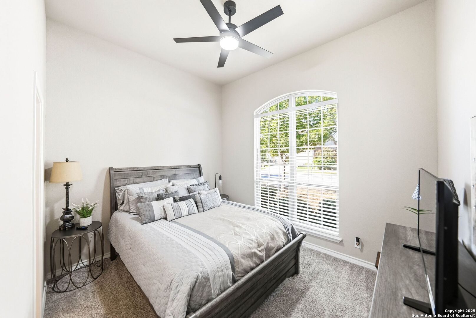 30622 Horseshoe Path Bulverde, TX 78163 - Photo 12 of 44 a bedroom with a bed flat screen tv and a window