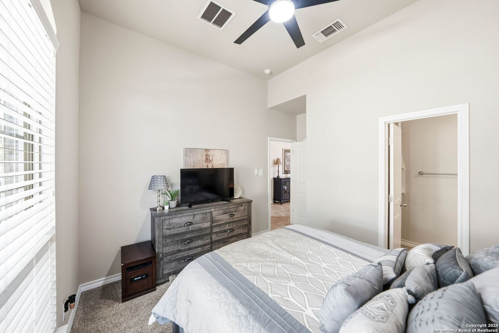 30622 Horseshoe Path Bulverde, TX 78163 - Photo 13 of 44 a bedroom with a bed and a flat screen tv