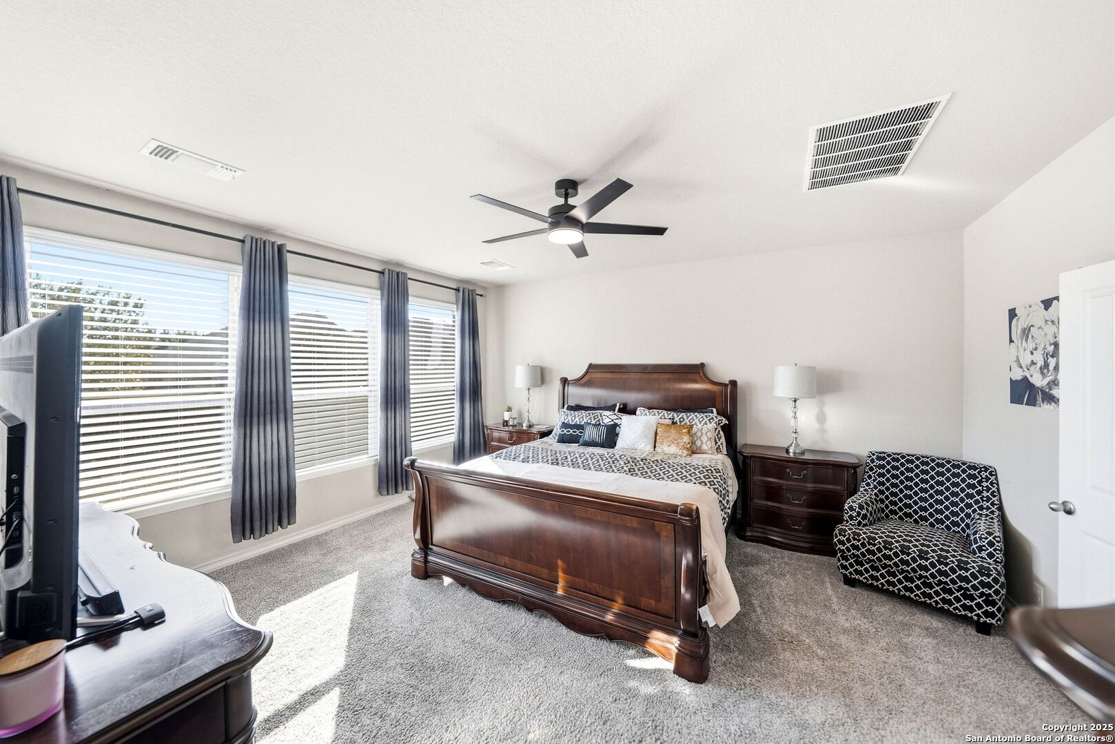 30622 Horseshoe Path Bulverde, TX 78163 - Photo 16 of 44 a bedroom with a bed and a chandelier
