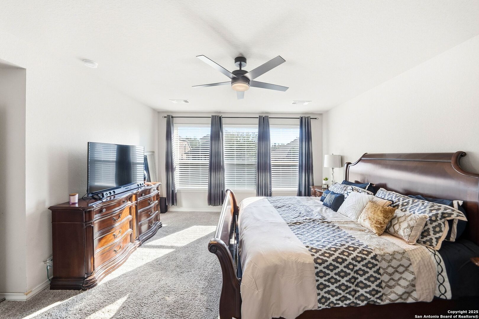 30622 Horseshoe Path Bulverde, TX 78163 - Photo 17 of 44 a bedroom with a bed and a flat screen tv