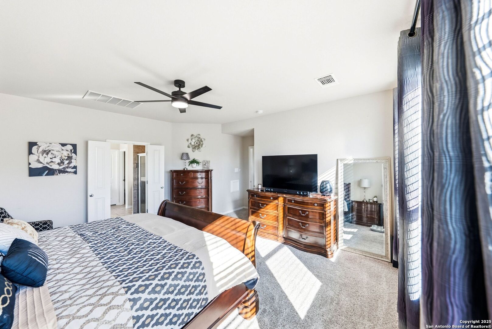 30622 Horseshoe Path Bulverde, TX 78163 - Photo 18 of 44 a bedroom with a bed and a flat screen tv