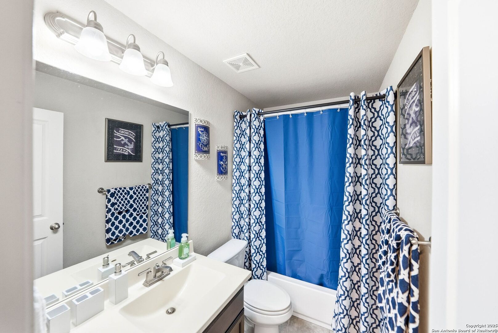 30622 Horseshoe Path Bulverde, TX 78163 - Photo 28 of 44 a bathroom with a sink a toilet and shower curtain