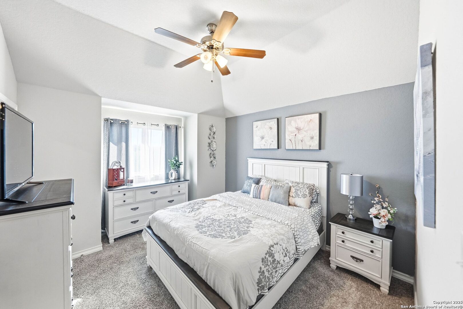 30622 Horseshoe Path Bulverde, TX 78163 - Photo 32 of 44 a bedroom with a bed and a chandelier