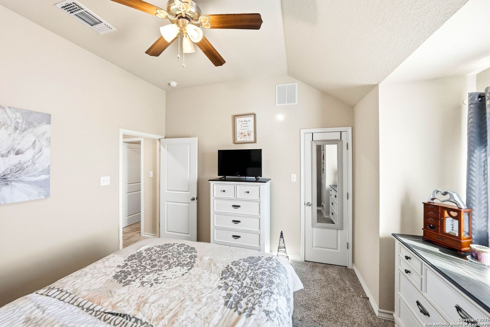 30622 Horseshoe Path Bulverde, TX 78163 - Photo 33 of 44 a bedroom with a bed and a flat tv screen on dresser