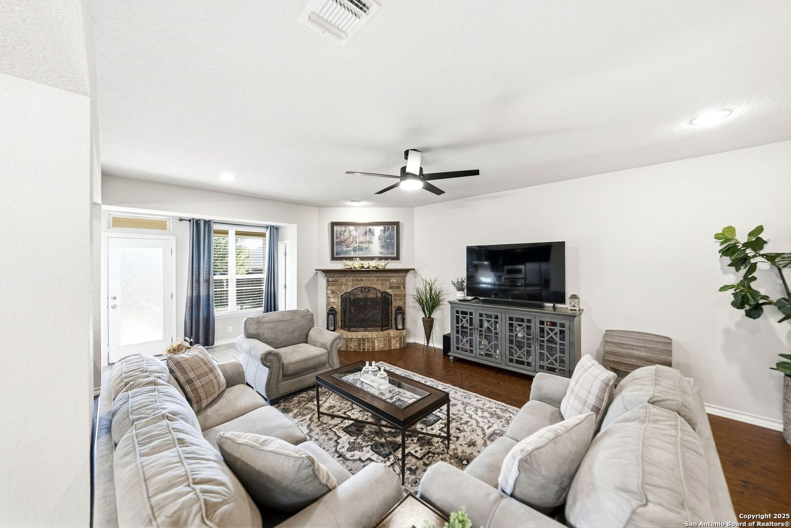 30622 Horseshoe Path Bulverde, TX 78163 - Photo 5 of 44 a living room with furniture a flat screen tv and a fireplace