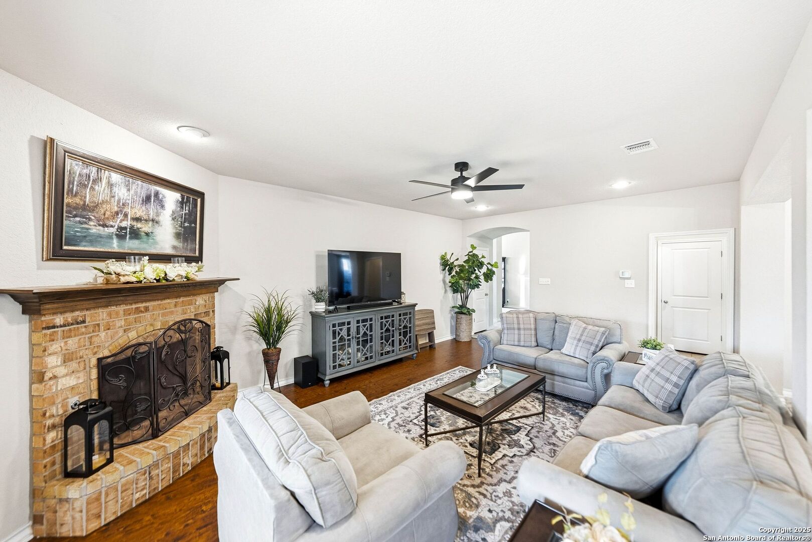 30622 Horseshoe Path Bulverde, TX 78163 - Photo 6 of 44 a living room with furniture a fireplace and a flat screen tv