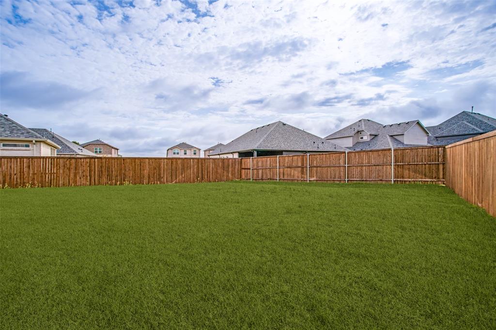 3115 Giovanni Point Princeton, TX 75407 - Photo 26 of 26 Expansive green lawn surrounded by a privacy fence
