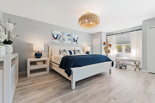 a bedroom with a bed and a chandelier
