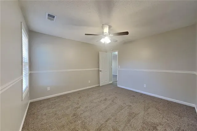an empty room with a empty space and a ceiling fan