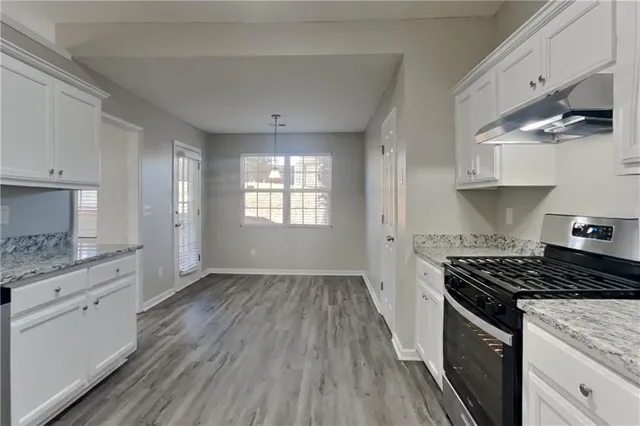 a kitchen with granite countertop a stove and a sink