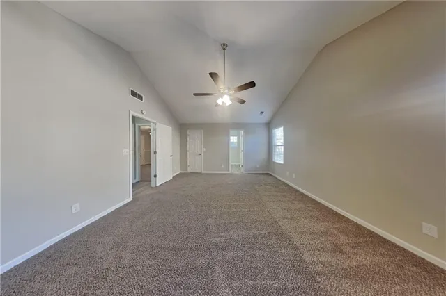 a view of a livingroom with a ceiling fan and window