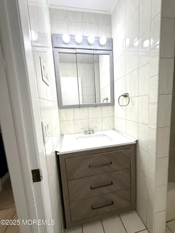 a bathroom with a sink and mirror