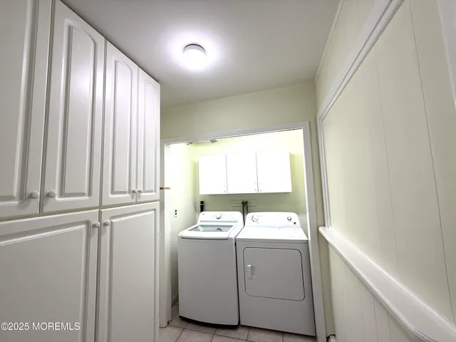 a room with a sink cabinets and a window