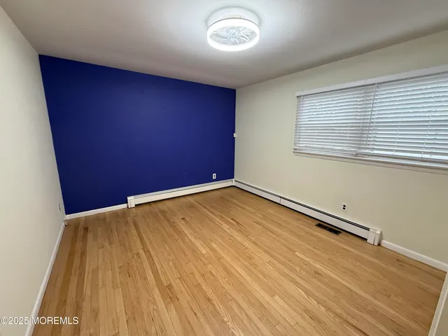 an empty room with wooden floor
