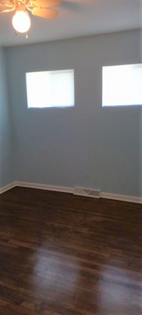 2762 Circle Drive Markham, IL 60428 - Photo 13 of 18 a view of an empty room with wooden floor and a window