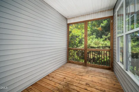 a view of a room with wooden floor and a fireplace